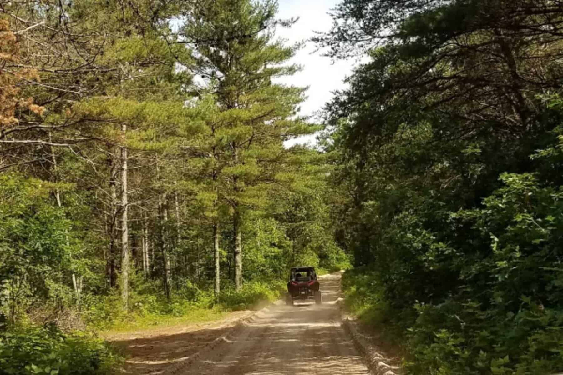 uoaib1g98sj.el7uas0rnyi.vl5saymjcc.off-road_vehicle_driving_down_a_dirt_trail uoaib1g98sj.el7uas0rnyi.vl5saymjcc.off road vehicle driving down a dirt trail scaled - Black River Area Chamber of Commerce